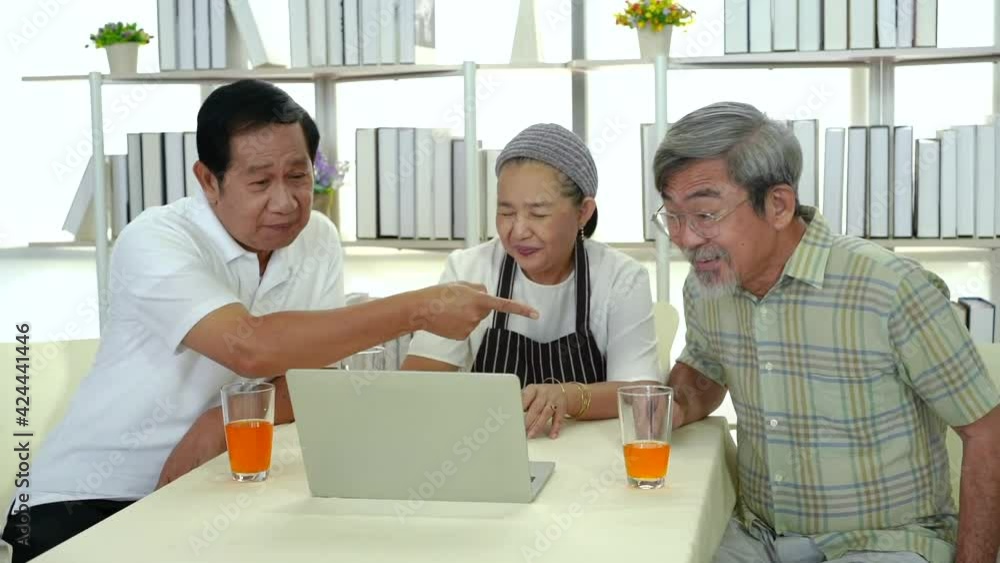 A group of elderly friends are meeting via laptop computers. Group of senior people conference or meeting computer. Orange juice. A group of elderly friends are meeting via laptop computers. Group of senior people conference or meeting computer. Orange juice.