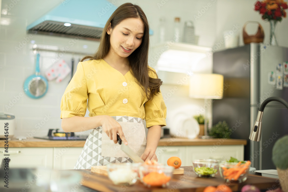 Woman cooking rice with vegetables in kitchen Woman cooking rice with vegetables in kitchen