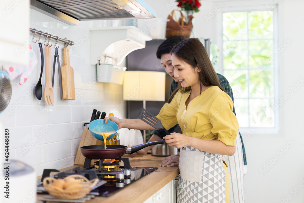 Portrait young couple in love helping to cook In a romantic atmosphere at home and looking at camera with smile face. Portrait young couple in love helping to cook In a romantic atmosphere at home and looking at camera with smile face.