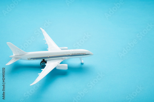 Model airplane on blue pastel color background.