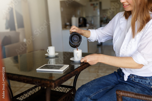 Bilde på lerret Cafe breakfast coffee lifestyle cropped woman pouring filter decaf from french press coffee maker at home or restaurant