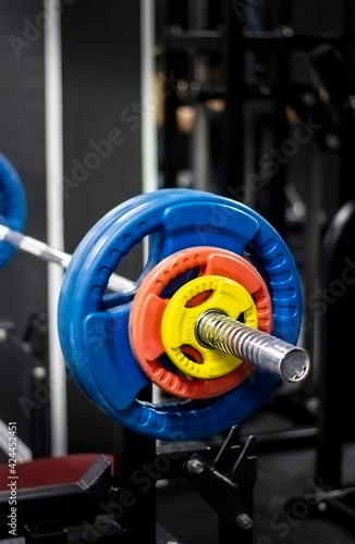 Barbell with colorful plates in the gym