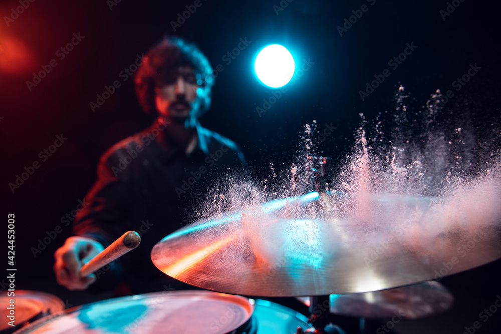 Drummer's rehearsing on drums before rock concert. Man recording music on drumset in studio Drummer's rehearsing on drums before rock concert. Man recording music on drumset in studio