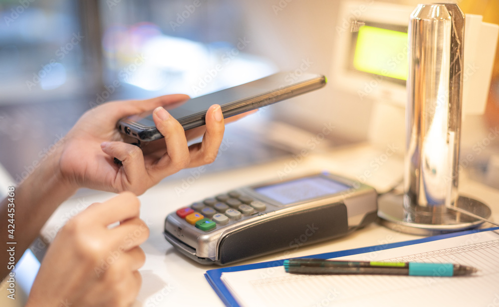 Fototapeta premium Customer making wireless or contactless payment using smartphone scan QR code for pay money .