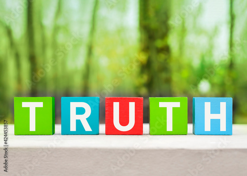 Konstfotografi Truth word written on wooden colorful blocks on a green nature background