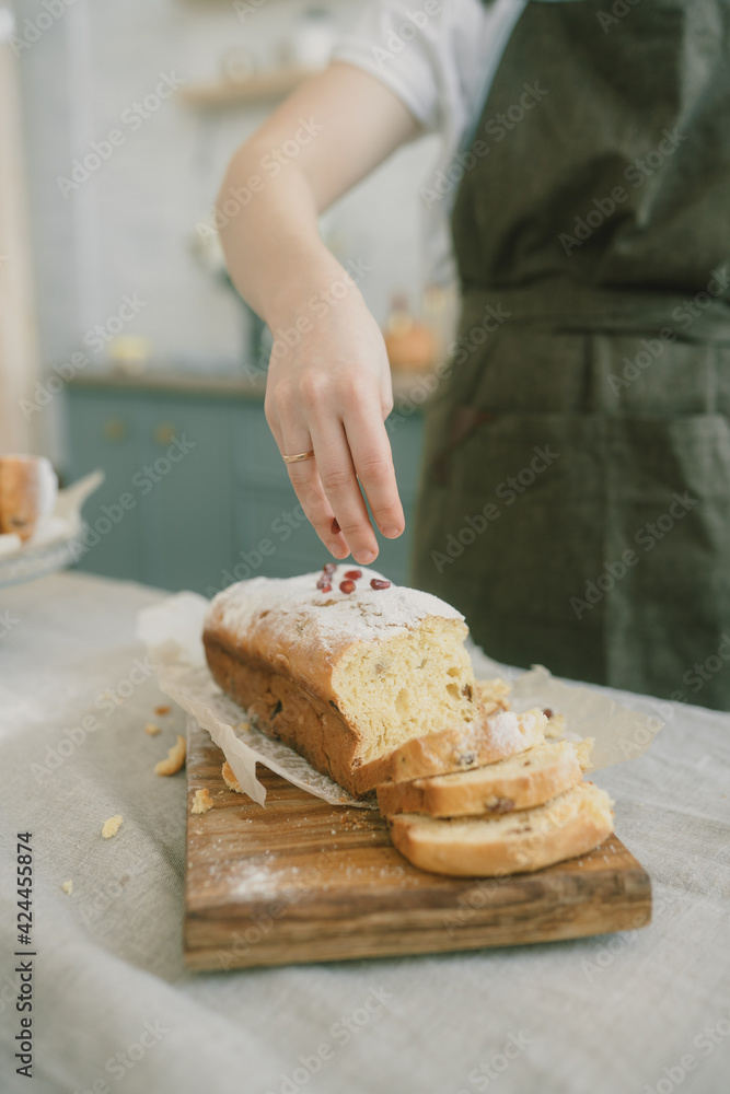 Women's hands sprinkle Easter bread with flour. Easter bread. Women's hands sprinkle Easter bread with flour. Easter bread.