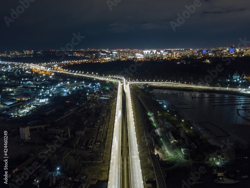 Automobile and railway bridge in Kiev. Night illumination of the bridge. Aerial drone view. © Sergey