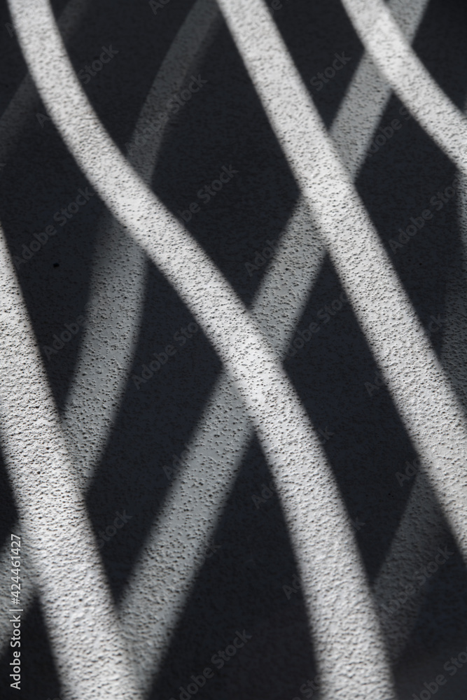 shadows and light on concrete textured surface for abstract background showing futuristic curved lines making various shapes and patterns of bent lines and curved waves vertical format room for type shadows and light on concrete textured surface for abstract background showing futuristic curved lines making various shapes and patterns of bent lines and curved waves vertical format room for type