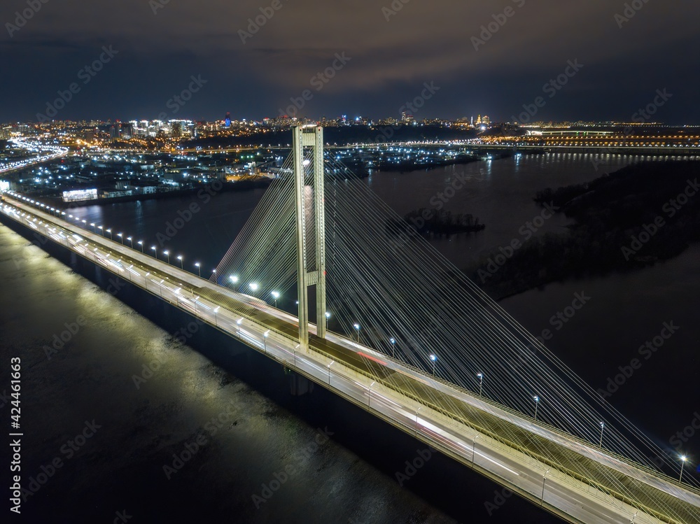 Obraz premium South automobile bridge in Kiev. Night illumination of the bridge. Aerial drone view.