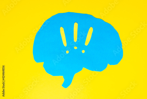 problem concept, blue brain layout with exclamation marks on yellow background