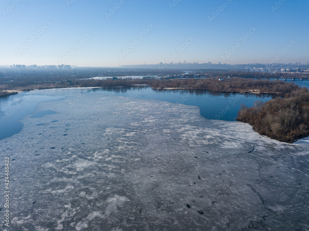 Frozen river in early spring. Aerial drone view. Frozen river in early spring. Aerial drone view.