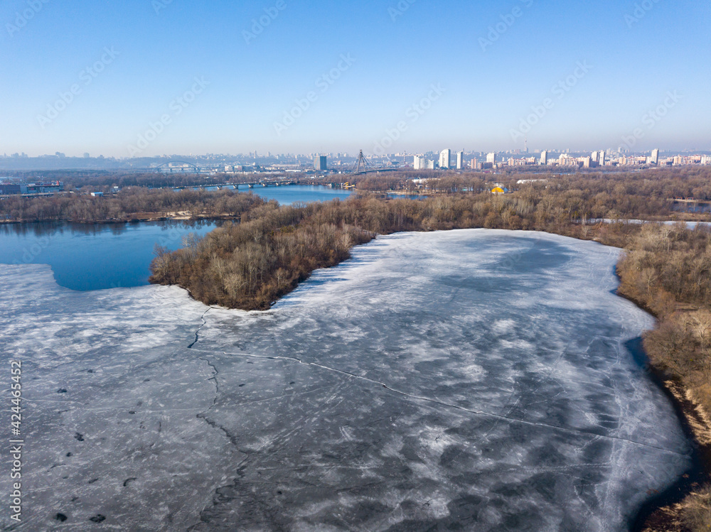 Frozen river in early spring. Aerial drone view. Frozen river in early spring. Aerial drone view.