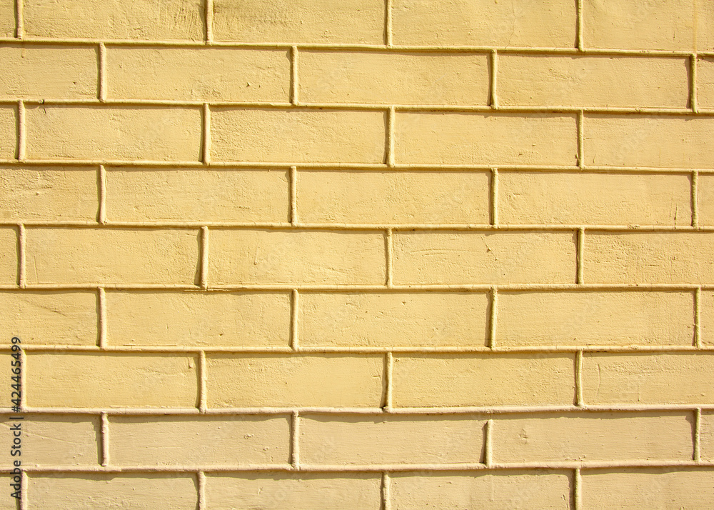 Obraz premium Yellow brick wall. background image for design.