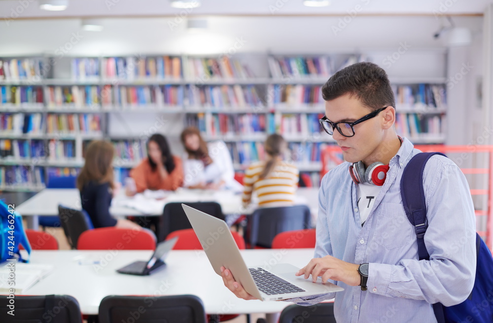 the student uses a notebook, latop and a school library the student uses a notebook, latop and a school library
