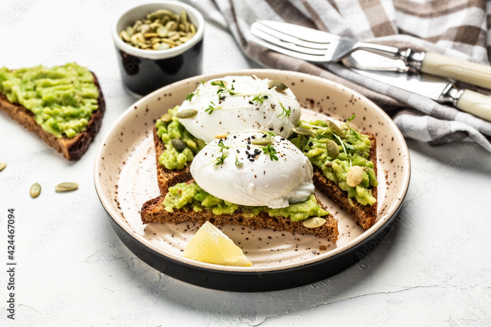sandwich with avocado and poached egg. Healthy food concept. Food recipe background. Close up sandwich with avocado and poached egg. Healthy food concept. Food recipe background. Close up