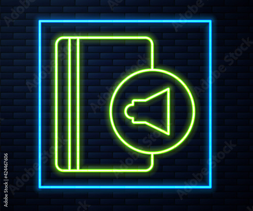 Glowing neon line Audio book icon isolated on brick wall background. Book with headphones. Audio guide sign. Online learning concept. Vector