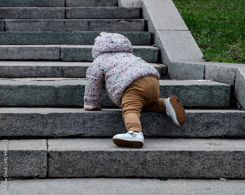 The child goes up the stairs.