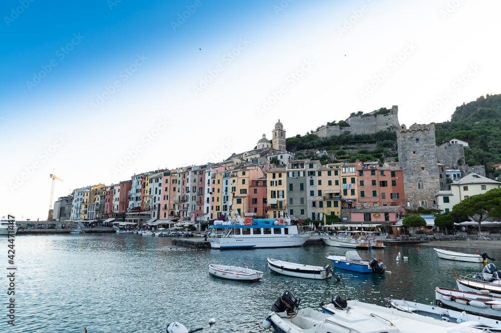 Porto Venere, Liguria, Italy. June 2020. Enchanting urban landscape of the colorful houses of the old town overlooking the harbor. Beautiful summer day.