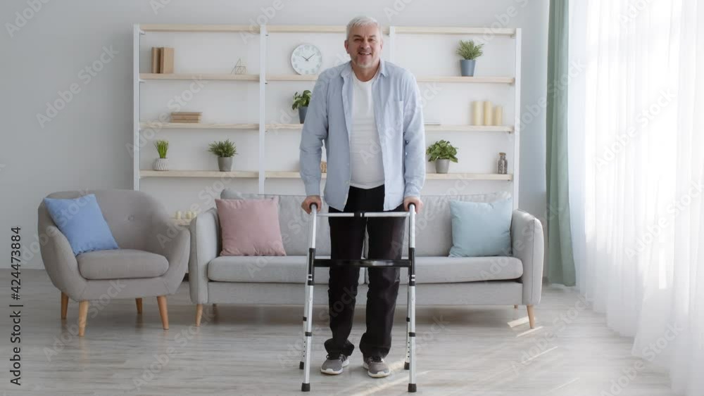 Disabled Man Making Step With Disability Walking Frame At Home Disabled Man Making Step With Disability Walking Frame At Home