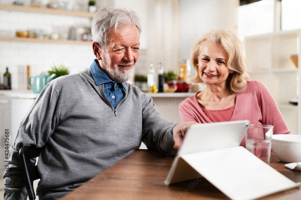Senior couple having video call. Happy husband and wife talking with their grandkids Senior couple having video call. Happy husband and wife talking with their grandkids