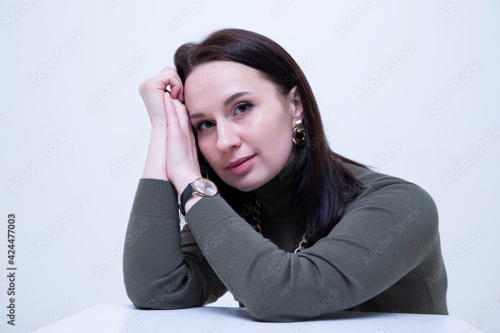 Fashion portrait of a young brunette woman in a dark golf Fashion portrait of a young brunette woman in a dark golf