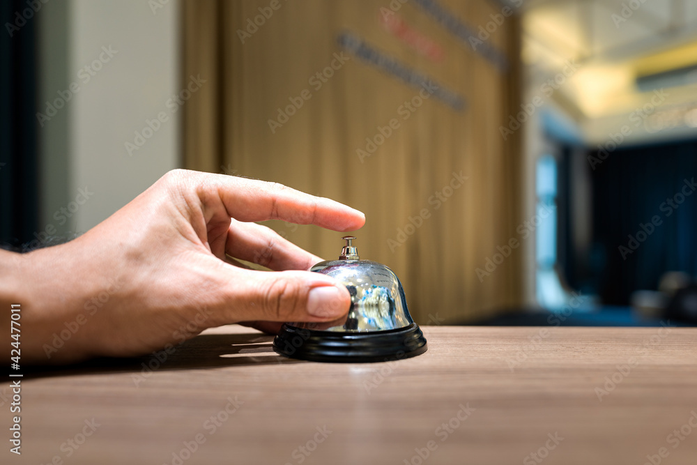 Human finger is pressing to ring the bell as a time keeper in meeting ...