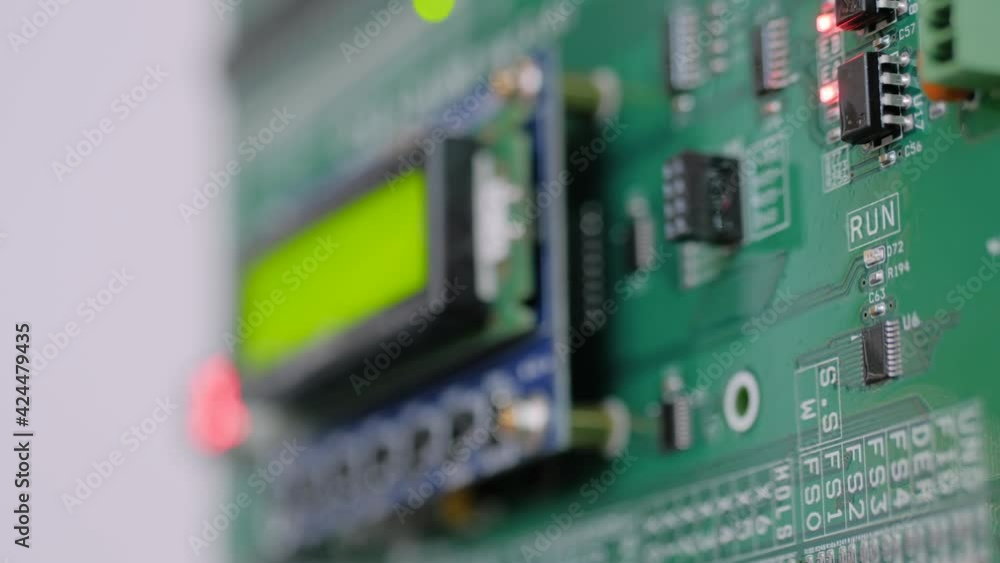 Green printed circuit board - pcb for elevator with digital display module at lift exhibition, trade show - close up view. Technology and electronic concept Green printed circuit board - pcb for elevator with digital display module at lift exhibition, trade show - close up view. Technology and electronic concept