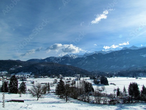 View of rural landscape near Bohinj in Gorenjska  Slovenai and mountains in Julian alps behind and the village of Stara Fuzina