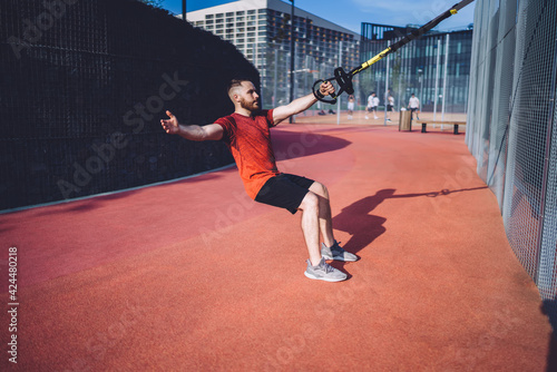 Strong athlete exercising on stadium