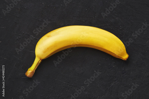 Banana on a dark textured background. Banana on a black background