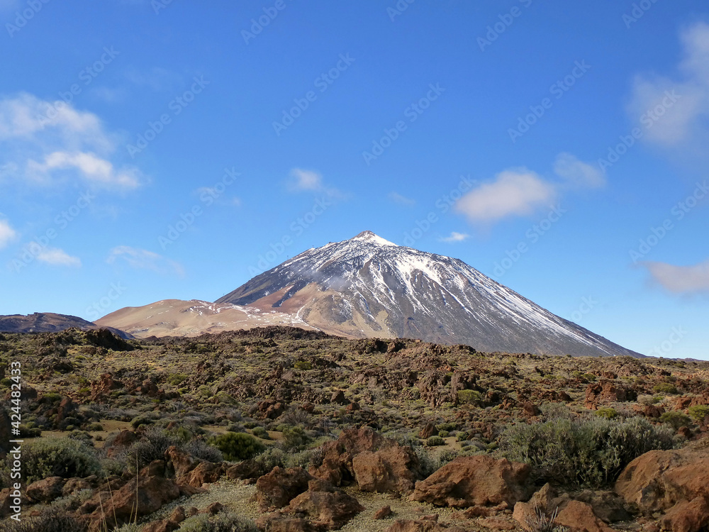 View of the volcano Mount Teide in Tenerife, Canary Islands, Spain, with snow in a sunny day