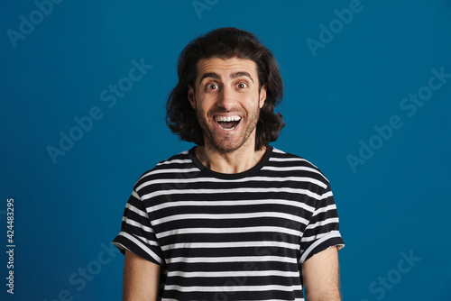 Unshaven brunette man in striped t-shirt looking at camera