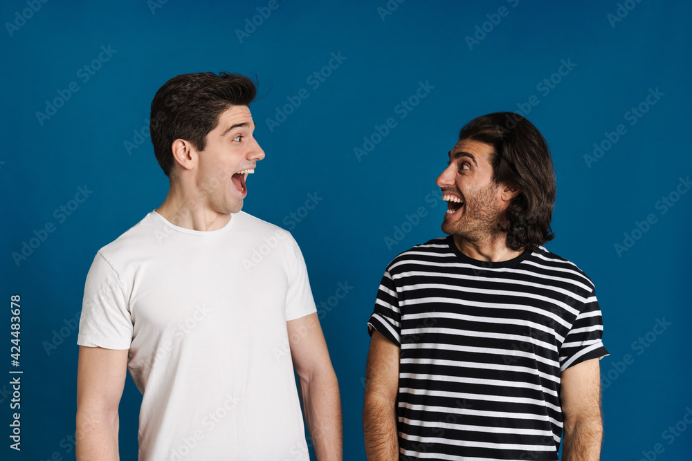 White excited two men exclaiming and looking at each other White excited two men exclaiming and looking at each other