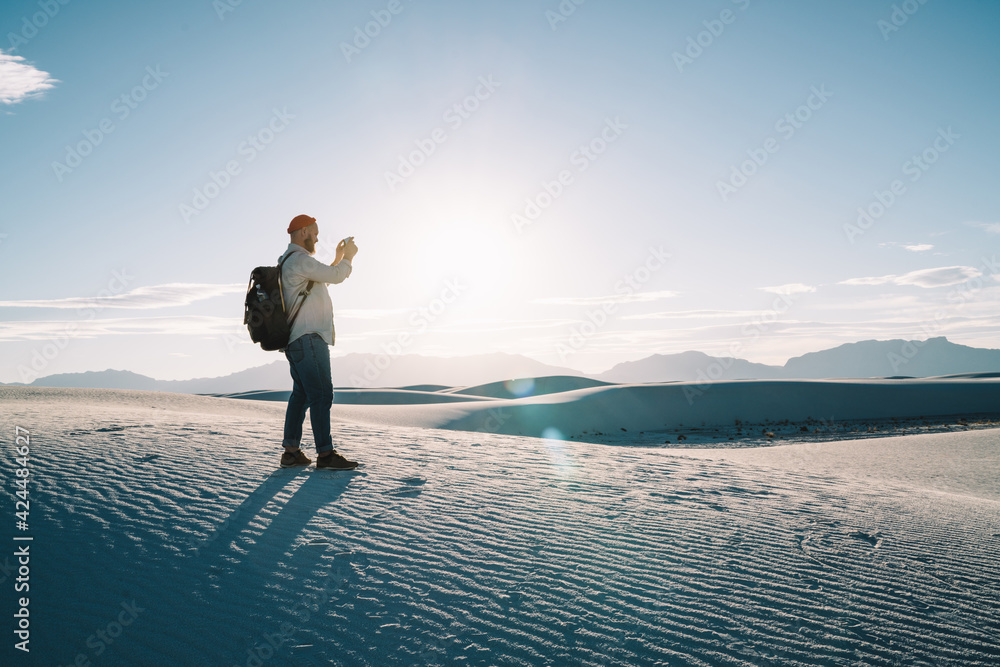Unrecognizable male tourist taking photos in desert Unrecognizable male tourist taking photos in desert