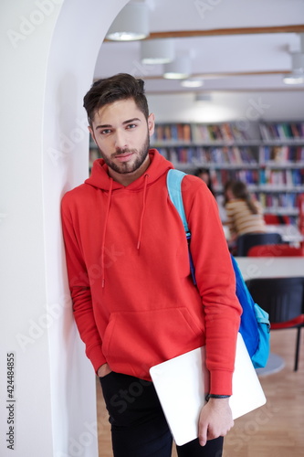 the student uses a laptop and a school library