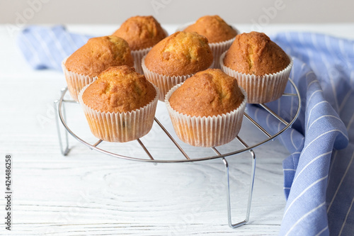 Quadro em tela Appetizing homemade muffins on a white wooden table