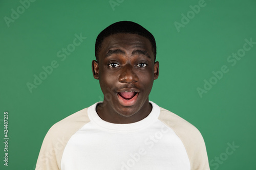 African man's portrait isolated on green studio background with copyspace