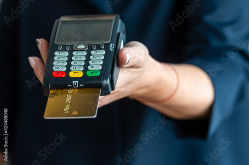 close-up of female hands hold terminal for payment by non-cash money