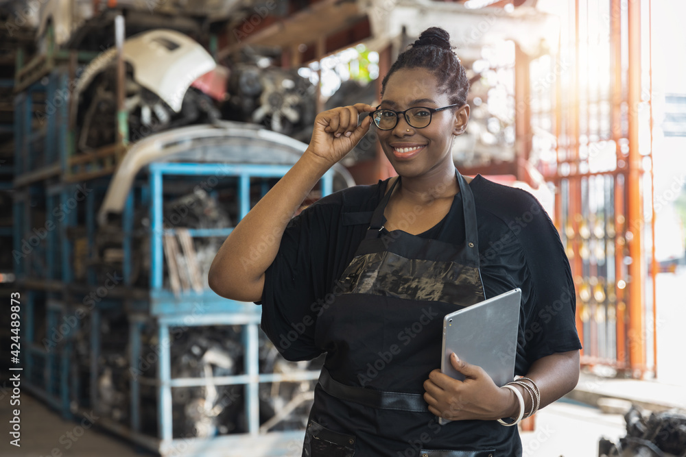 Fototapeta premium portrait of confident black African woman worker wearing glass and smile in industry, smiled for customer service concept