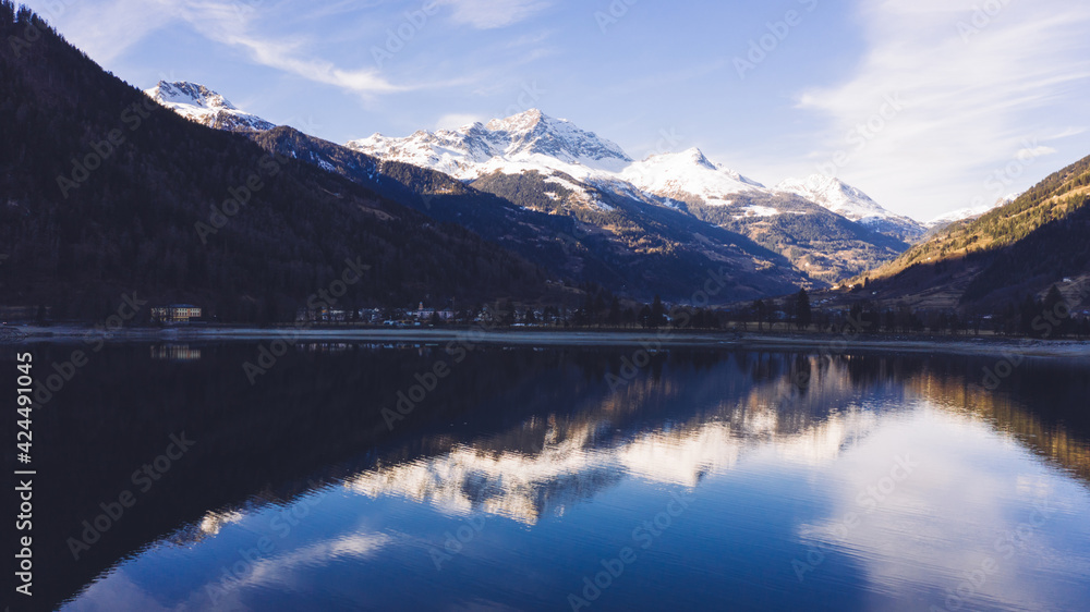Calm lake near snowy mountains