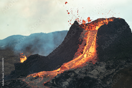 Volcanic eruption in Iceland  lava bursting from the volcano.  Bright yellow magma. 