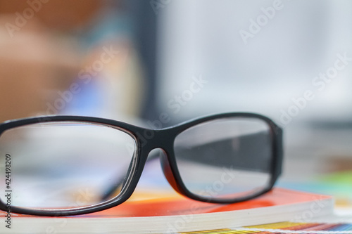 The glasses placed on the desk are pre-made glasses for working in order to increase the field of view for designers who need work eyesight. Concept of wearing eyeglasses to increase the visual acuity
