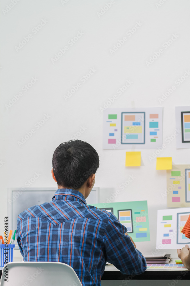 Obraz premium Smooth Focus,A team of UI UX web designers are working together to develop a mobile responsive website with UI UX Front End Designer Previewing. Website development concept UI UX front end designer