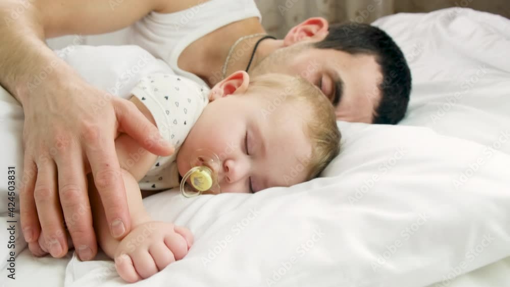 dad puts little baby to bed. selective focus. dad puts little baby to bed. selective focus.