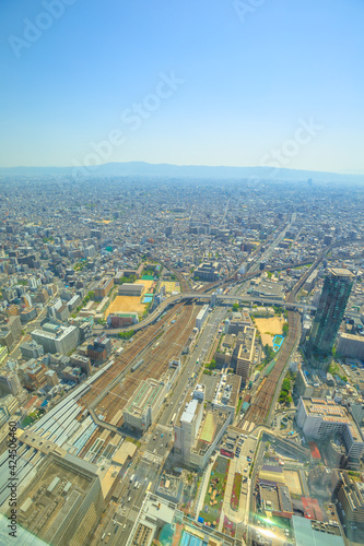 Osaka, Japan - April 30, 2017: aerial view of Tennoji zoo and Osaka cityscape from a top of Osaka's Abeno Harukas, the tallest skyscraper in Japan. Blue sky with copy space. Vertical.