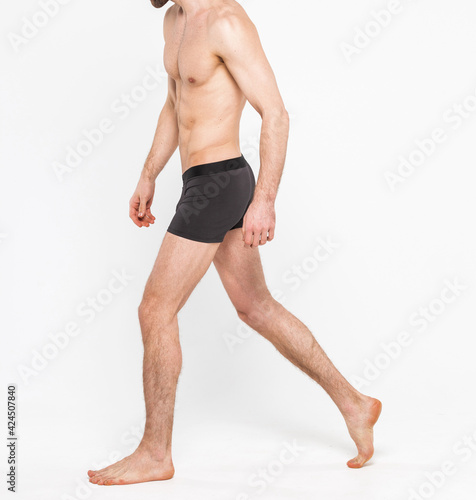 Muscular young man wearing underwear isolated on white background. Underwear for men copy space