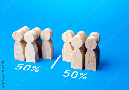 The group of people is divided equally by line. Visualization of statistical data. 50% of 100%. Dividing people into two groups on different issues. Polls test results. Equality in numbers photo