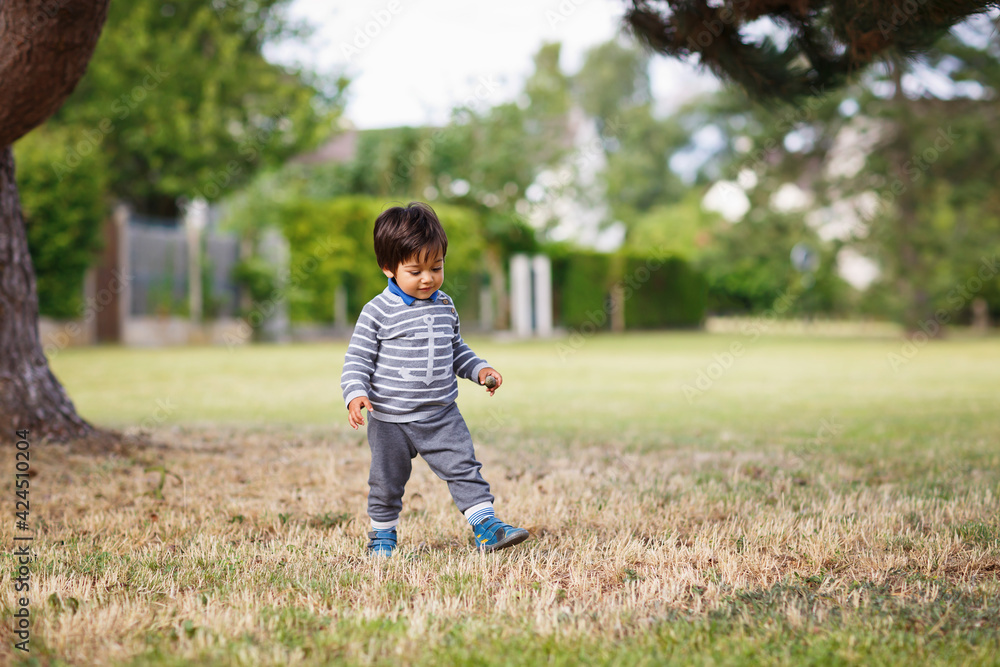 Little eastern handsome baby boy playing outdoor in the park Little eastern handsome baby boy playing outdoor in the park