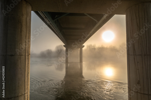sunrise by the foggy river