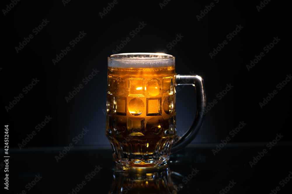 Frosty glass of light beer set isolated on a black background Frosty glass of light beer set isolated on a black background